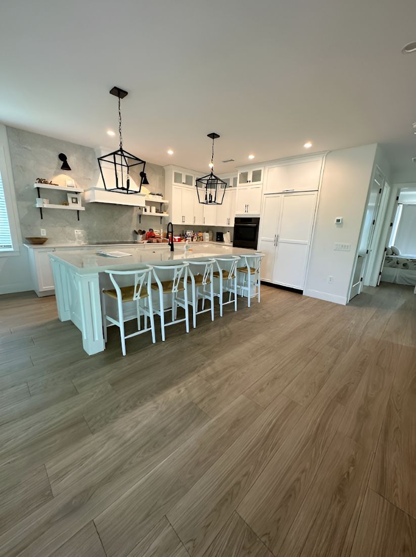 Open kitchen with large island and lantern pendants, cleaned and polished