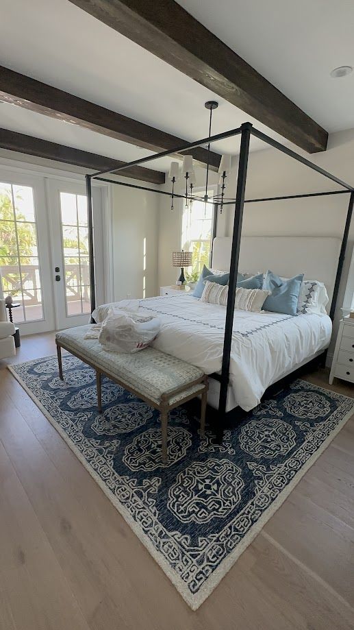 Bedroom with four-poster bed and crisp white linens