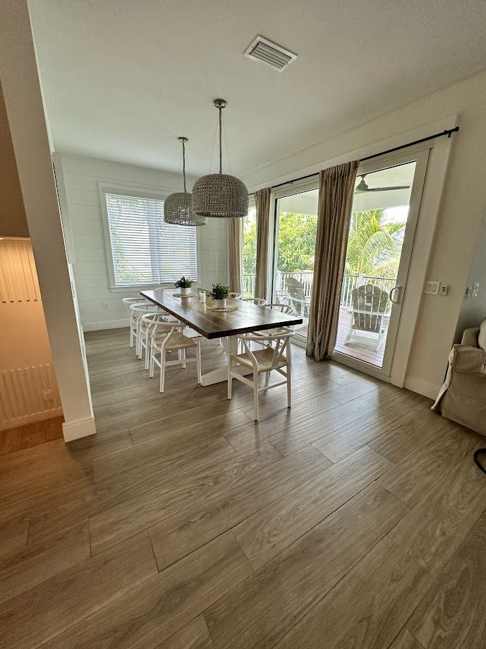 Dining room with table set beside sliding balcony doors