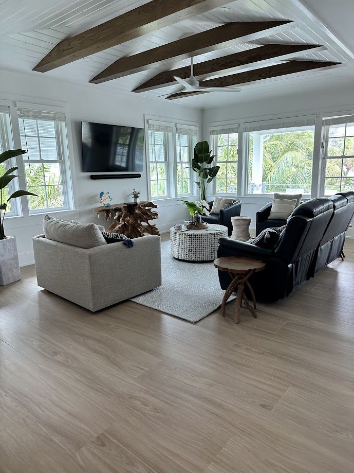 Bright great room with wood ceiling beams, dusted and vacuumed