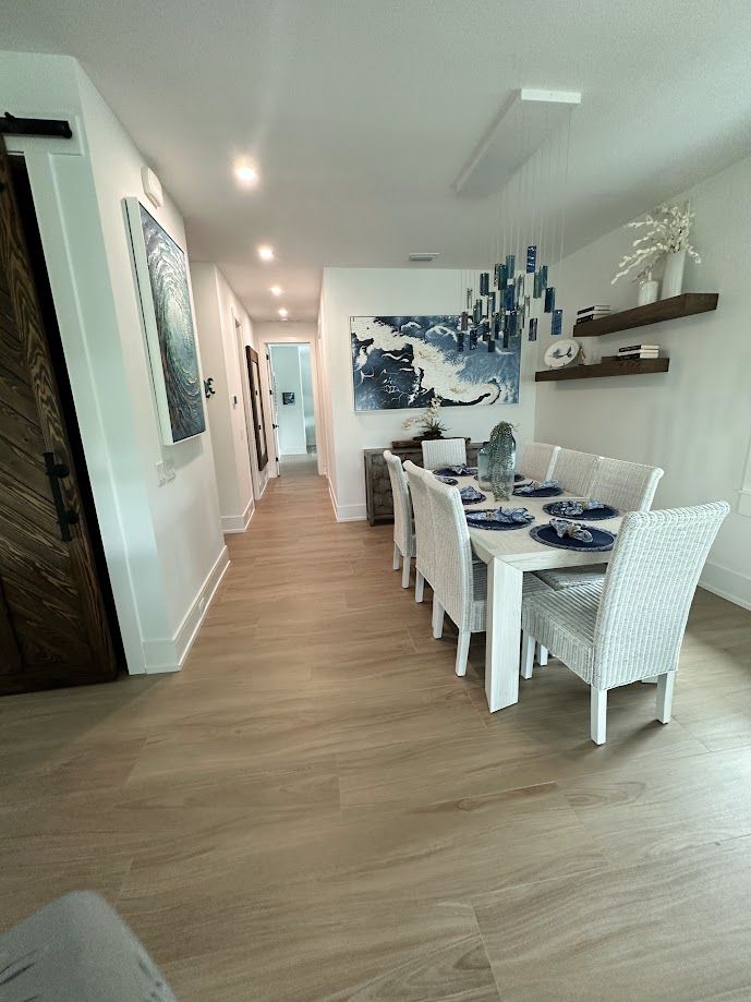Dining nook with set table, floating shelves and barn door